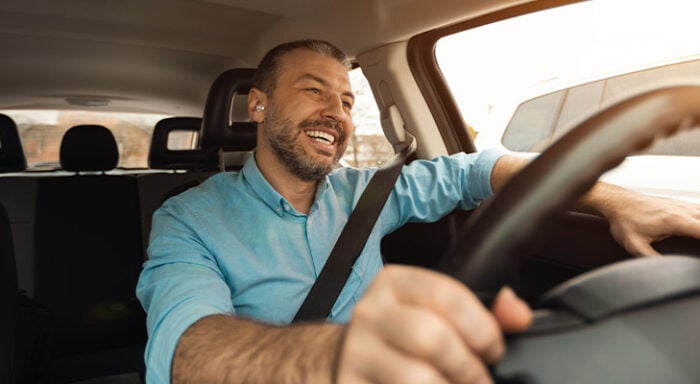 Man driving and smiling