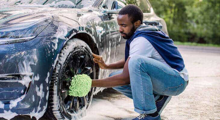 Man washing his electric car