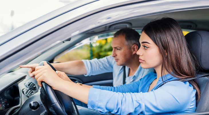 parent teaching teen how to drive