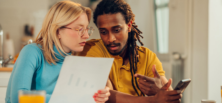 couple looking at car insurance paperwork