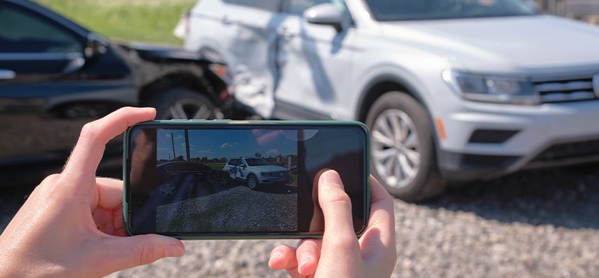 Car damage being photographed by phone