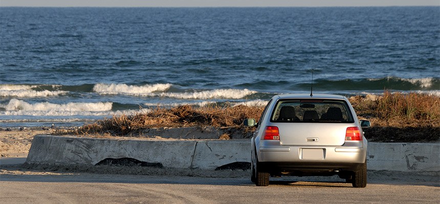 Grey car parked by the shore
