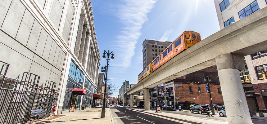 Downtown street in Detroit featuring train