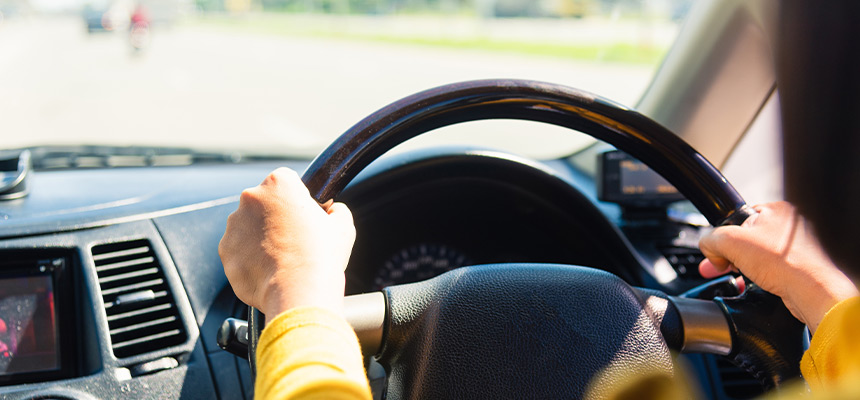 Closeup of hands in steering wheel