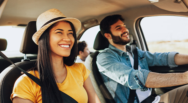 family smiling in car