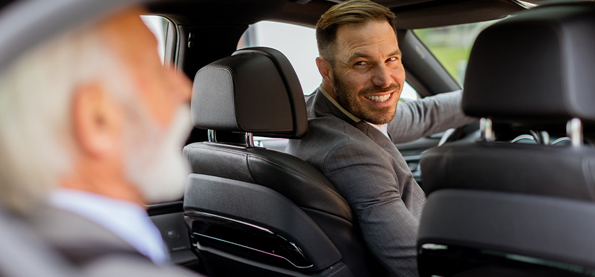 Rideshare driver staring at the senior passenger sat in the back