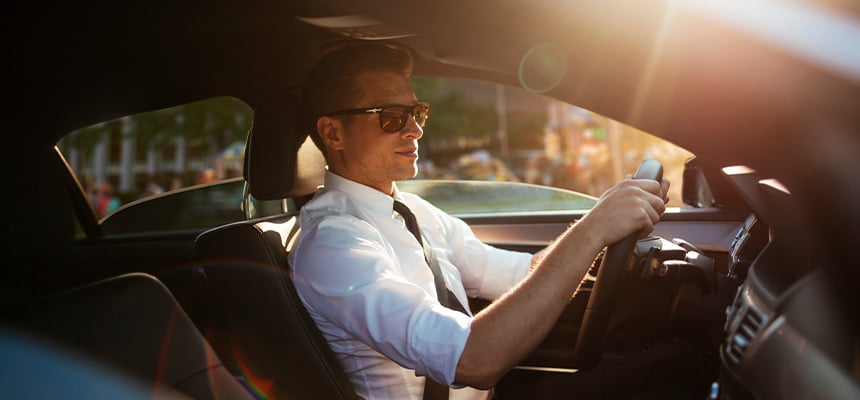 Rideshare driver wearing a suit and sunglasses