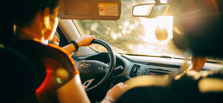 Woman driving a Kia car