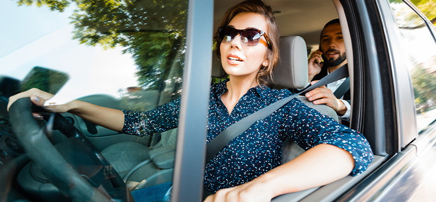 Female rideshare driver with sunglasses