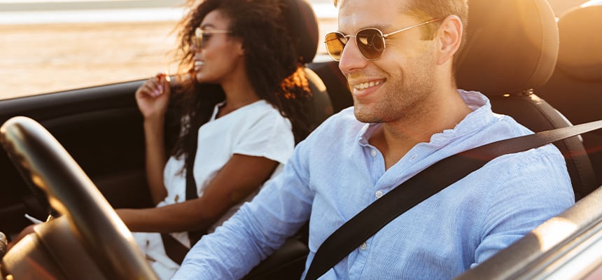 Young couple with sunglasses driving