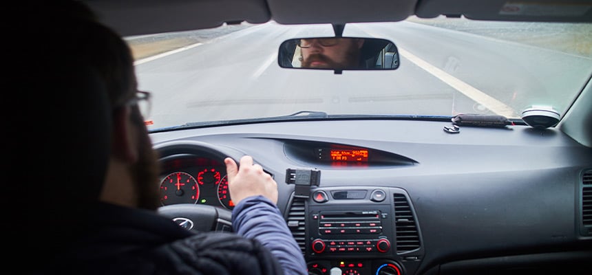 Back view of man driving car