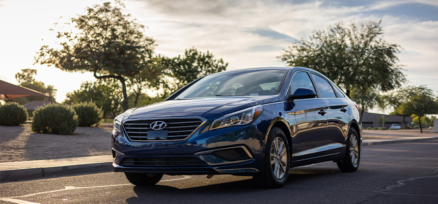 Blue Hyundai car being driven during daylight