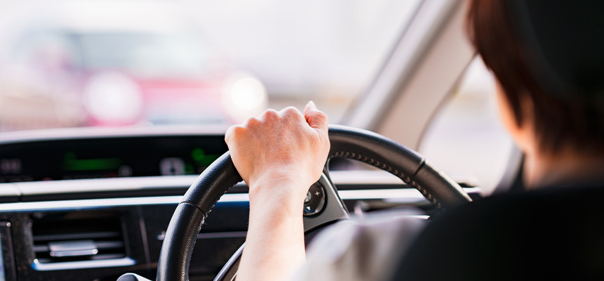 Driver hand on steering wheel