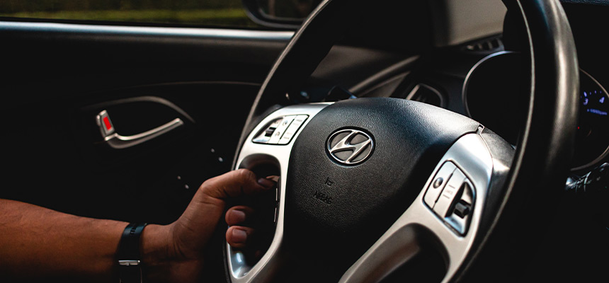 Driver gripping Hyundai steering wheel