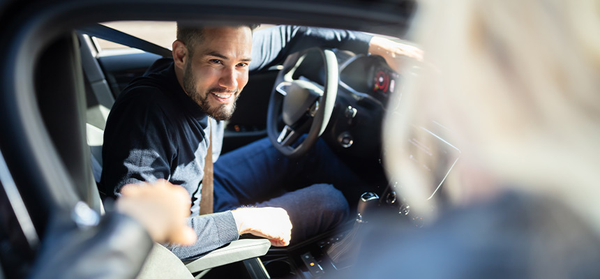 Rideshare driver talking to a passenger